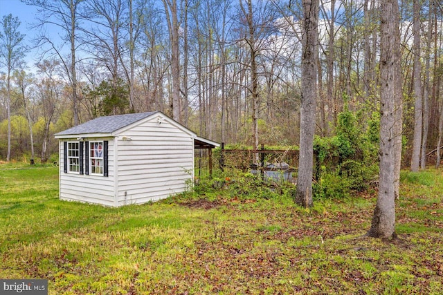 view of outdoor structure with an outbuilding and a wooded view