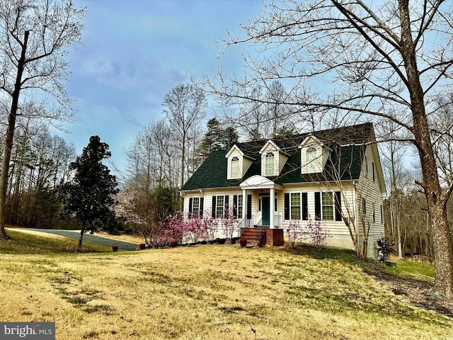 cape cod-style house featuring a front yard