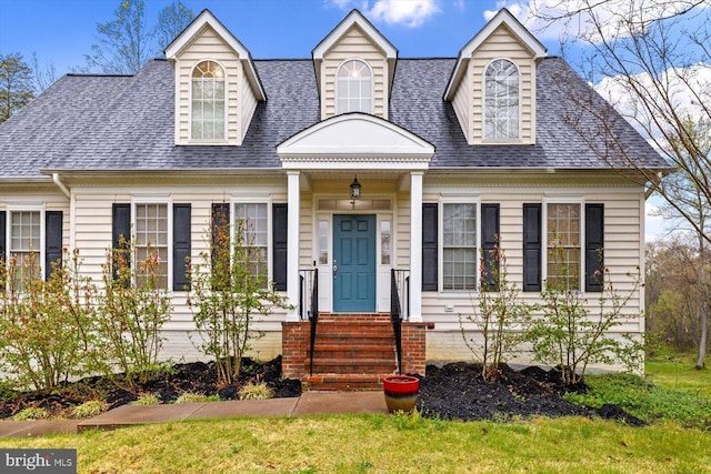 cape cod home with roof with shingles