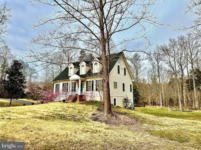 cape cod-style house featuring a front yard