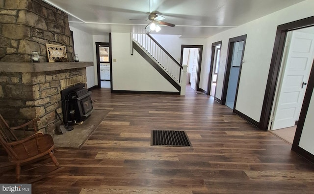 1636 Narrows Rd, Howard, PA 16841 - unfurnished living room with stairway, a wood stove, dark wood-style flooring, ceiling fan, and visible vents