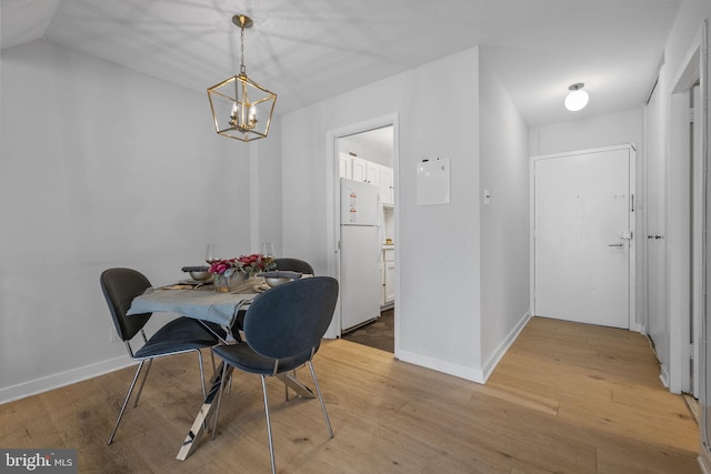 2201 L St NW Unit 515, Washington, DC 20037 - dining space featuring a chandelier and light wood-type flooring