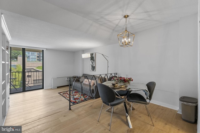 2201 L St NW Unit 515, Washington, DC 20037 - dining room featuring a chandelier and wood finished floors