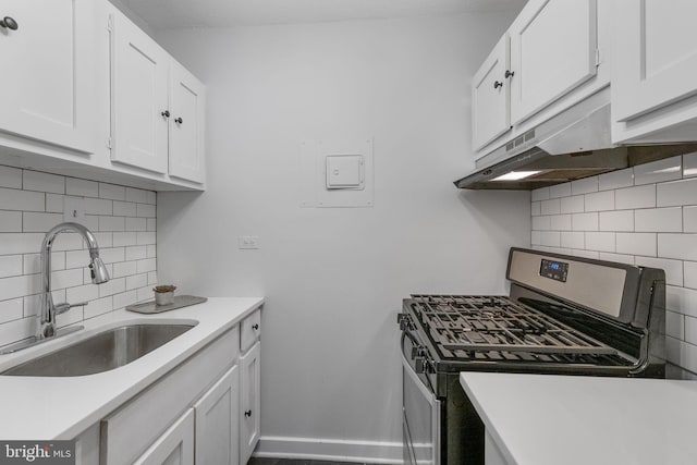 2201 L St NW Unit 515, Washington, DC 20037 - kitchen with stainless steel range with gas cooktop, decorative backsplash, white cabinetry, and light countertops
