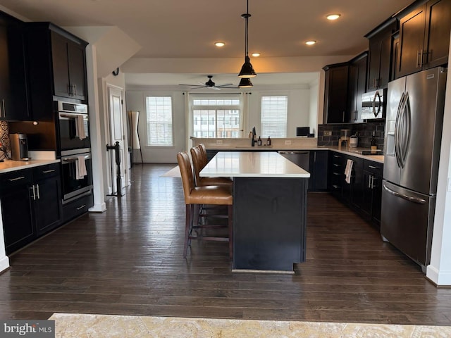 8676 Underhill Ln, Manassas, VA 20112 - kitchen with dark wood-style flooring, a sink, and stainless steel appliances