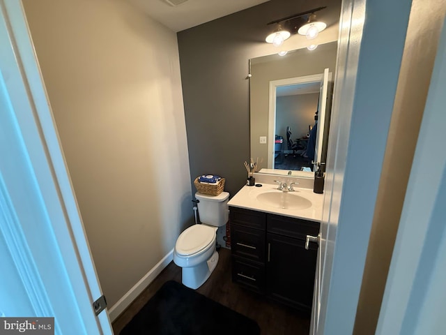8676 Underhill Ln, Manassas, VA 20112 - half bath with toilet, wood finished floors, and vanity