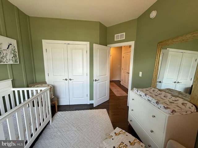 8676 Underhill Ln, Manassas, VA 20112 - bedroom with visible vents, baseboards, a closet, a crib, and dark wood finished floors