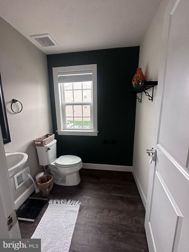 8676 Underhill Ln, Manassas, VA 20112 - bathroom featuring toilet, wood finished floors, baseboards, and visible vents