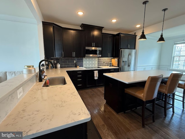 8676 Underhill Ln, Manassas, VA 20112 - kitchen featuring dark wood finished floors, light countertops, decorative backsplash, stainless steel appliances, and a sink