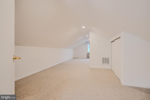 additional living space featuring baseboards, recessed lighting, visible vents, lofted ceiling, and carpet