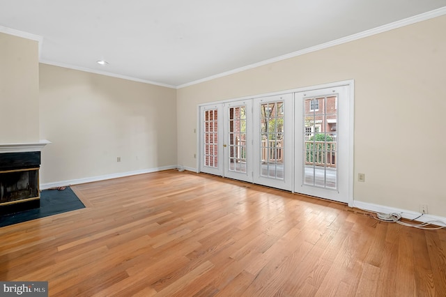 922 Fell St, Baltimore, MD 21231 - unfurnished living room with crown molding, baseboards, light wood finished floors, and a fireplace with flush hearth