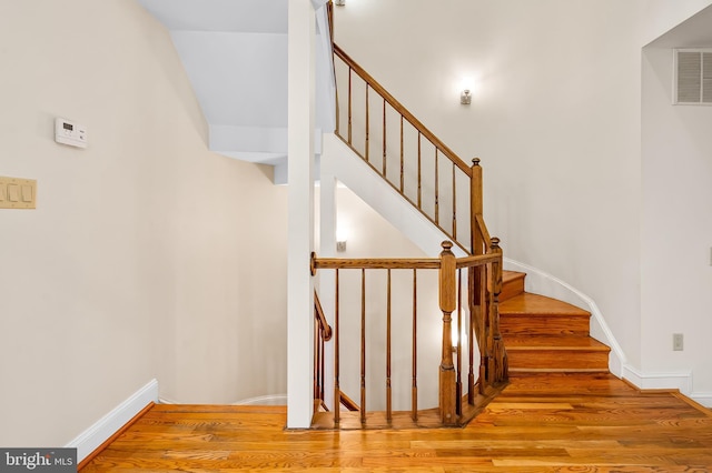 922 Fell St, Baltimore, MD 21231 - staircase featuring visible vents, baseboards, and wood finished floors