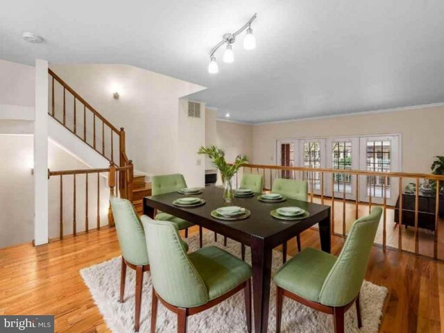 922 Fell St, Baltimore, MD 21231 - dining area featuring stairs, visible vents, and wood finished floors