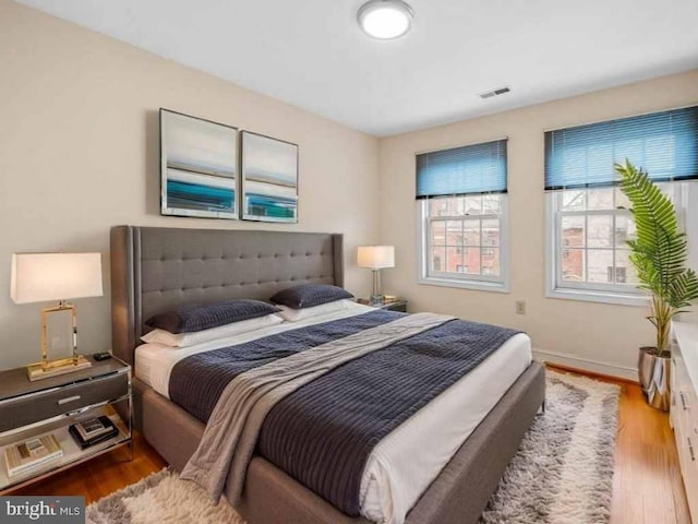 922 Fell St, Baltimore, MD 21231 - bedroom with visible vents, baseboards, and wood finished floors