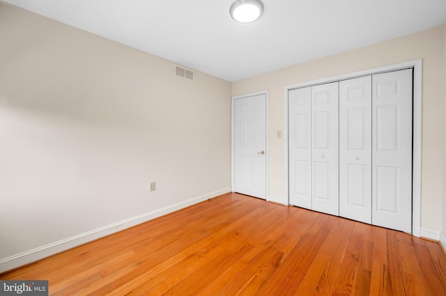 922 Fell St, Baltimore, MD 21231 - unfurnished bedroom featuring visible vents, baseboards, light wood-type flooring, and a closet