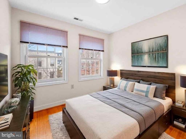 922 Fell St, Baltimore, MD 21231 - bedroom featuring wood finished floors, baseboards, and visible vents