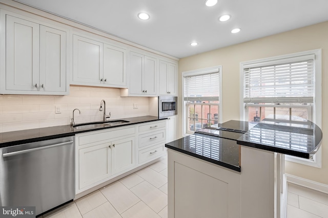 922 Fell St, Baltimore, MD 21231 - kitchen featuring light tile patterned floors, a sink, appliances with stainless steel finishes, recessed lighting, and backsplash