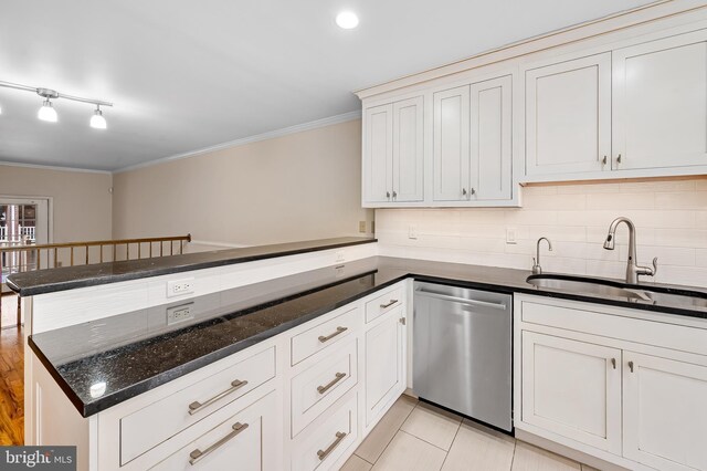 922 Fell St, Baltimore, MD 21231 - kitchen with dishwasher, a sink, ornamental molding, a peninsula, and dark stone counters