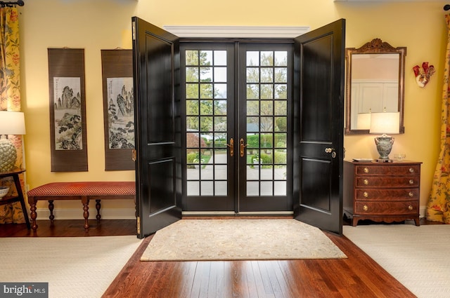 entryway featuring french doors, baseboards, and hardwood / wood-style flooring