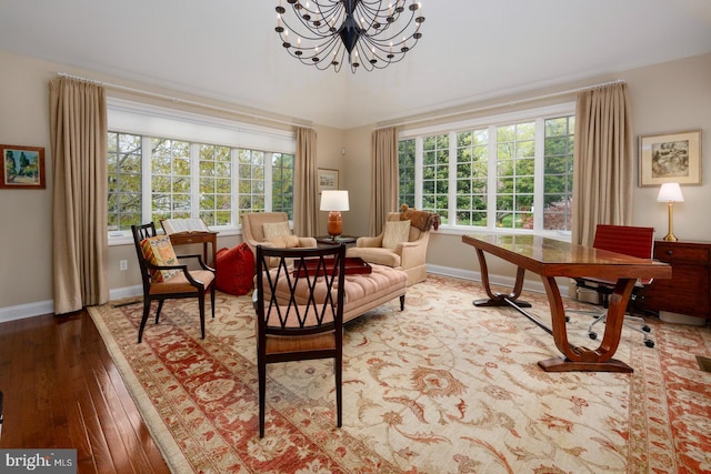 sitting room featuring a healthy amount of sunlight, an inviting chandelier, baseboards, and hardwood / wood-style flooring