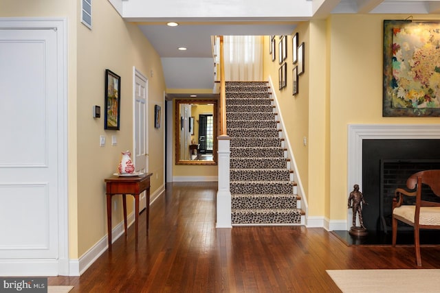 staircase featuring baseboards and hardwood / wood-style floors