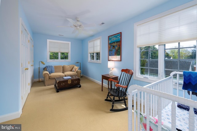 carpeted bedroom featuring visible vents, baseboards, and multiple windows