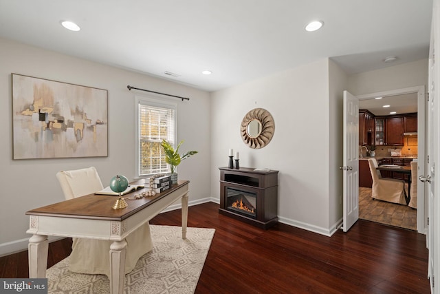 home office with baseboards, visible vents, and dark wood-type flooring