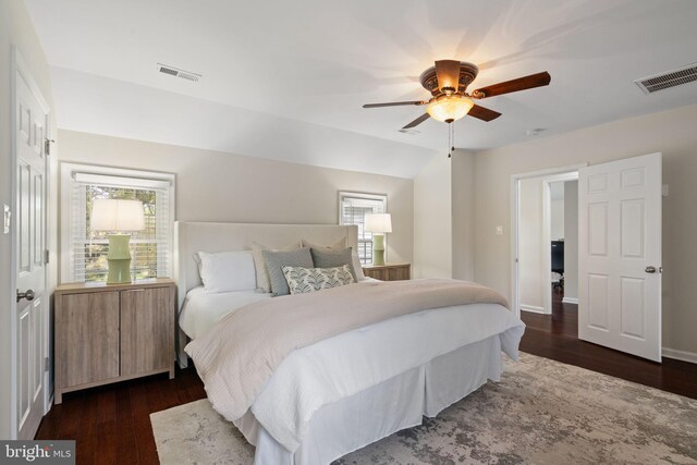 bedroom featuring multiple windows, visible vents, and dark wood-style flooring