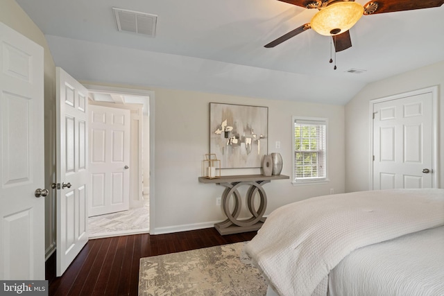 bedroom featuring wood-type flooring, baseboards, vaulted ceiling, and visible vents