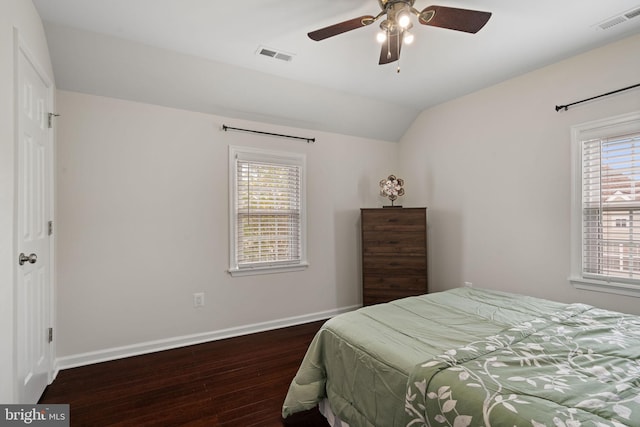 bedroom featuring baseboards, wood finished floors, and visible vents