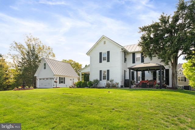 rear view of property featuring an outbuilding, a standing seam roof, a gazebo, cooling unit, and metal roof