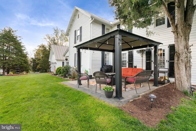 back of property with a yard, a gazebo, an outdoor living space, and a patio area