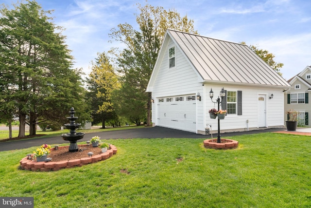 view of side of home featuring a standing seam roof, a lawn, an outdoor structure, and metal roof