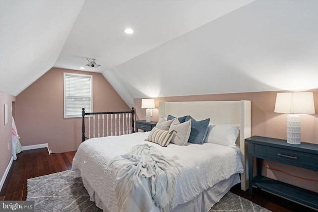 bedroom with wood finished floors, lofted ceiling, and baseboards