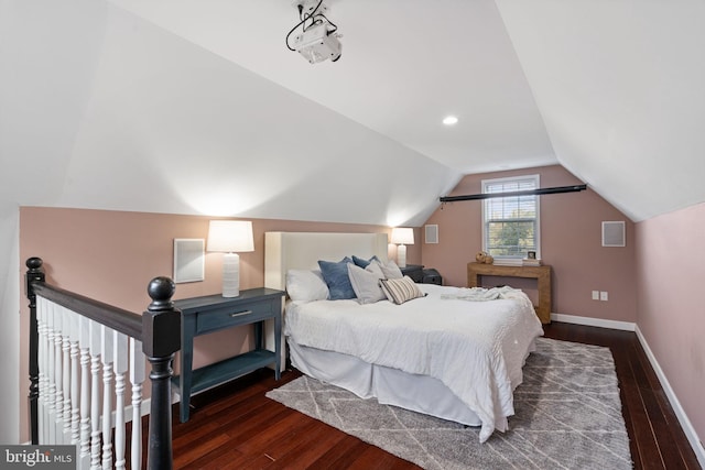 bedroom featuring lofted ceiling, dark wood-type flooring, and baseboards