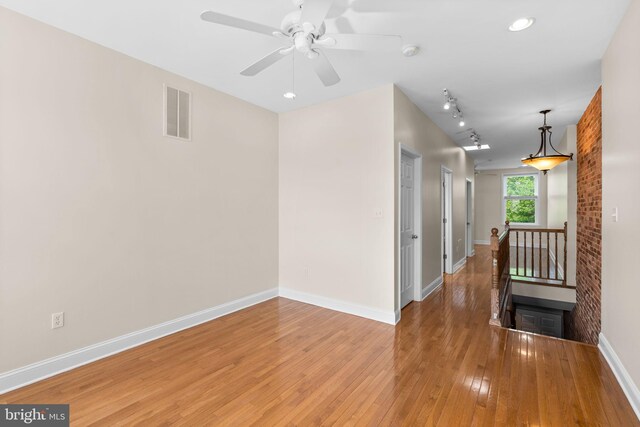 2415 Saint Paul St, Baltimore, MD 21218 - spare room with baseboards, light wood-style flooring, a ceiling fan, and a smoke detector