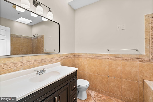 2415 Saint Paul St, Baltimore, MD 21218 - bathroom with a skylight, toilet, vanity, tile walls, and tiled shower