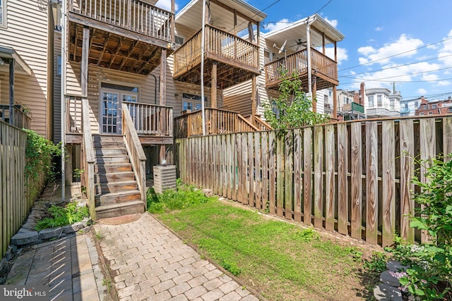 2415 Saint Paul St, Baltimore, MD 21218 - back of property featuring stairway, a fenced backyard, ceiling fan, and a balcony