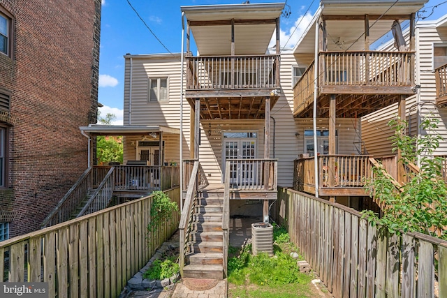 2415 Saint Paul St, Baltimore, MD 21218 - back of property with stairway, central AC unit, fence, and a balcony