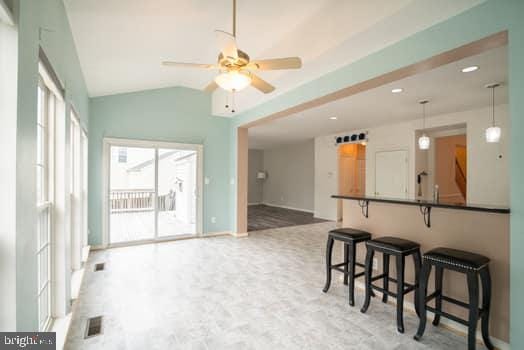 17661 Avenel Ln, Dumfries, VA 22026 - kitchen featuring a ceiling fan, a kitchen breakfast bar, decorative light fixtures, vaulted ceiling, and recessed lighting