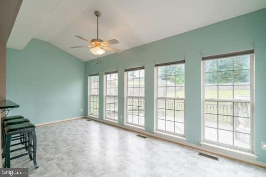 17661 Avenel Ln, Dumfries, VA 22026 - unfurnished living room featuring vaulted ceiling, plenty of natural light, ceiling fan, and baseboards
