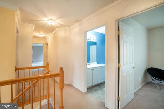 17661 Avenel Ln, Dumfries, VA 22026 - corridor featuring an upstairs landing, light carpet, and crown molding