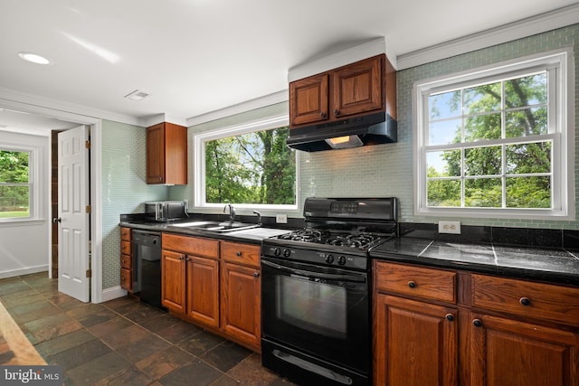 kitchen featuring under cabinet range hood, black appliances, a sink, plenty of natural light, and crown molding