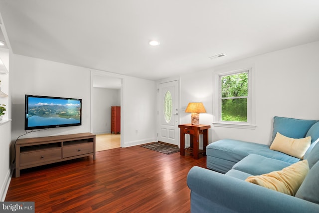 living area with wood finished floors, baseboards, and recessed lighting