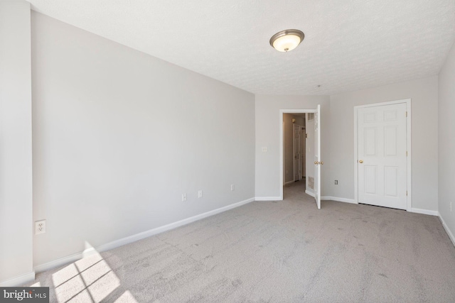 unfurnished bedroom with baseboards, carpet floors, and a textured ceiling