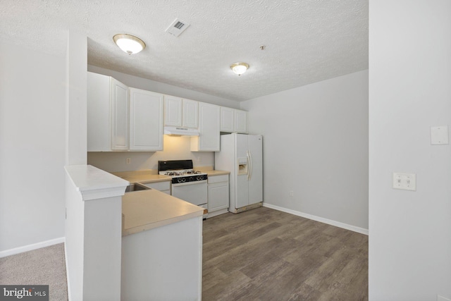 kitchen featuring light countertops, white cabinets, white appliances, baseboards, and under cabinet range hood