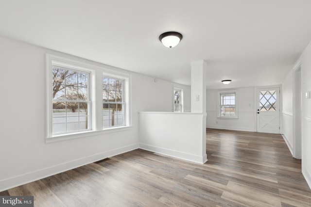 entrance foyer featuring baseboards and wood finished floors
