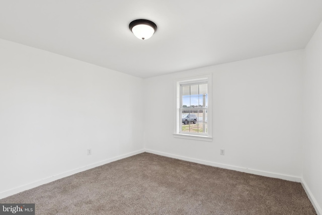 unfurnished room featuring baseboards and carpet flooring