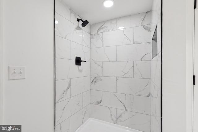 full bath featuring a tile shower