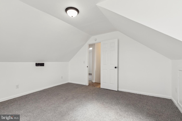 bonus room with carpet flooring, baseboards, and vaulted ceiling